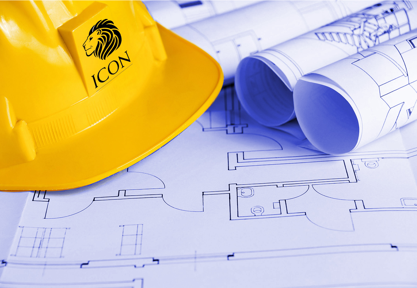 a yellow hardhat on blueprints